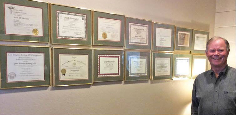 Dr. Mooney with some of his many certificates and awards.