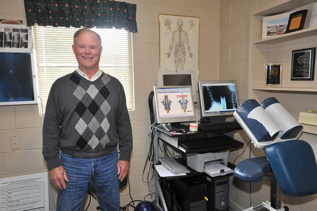 John Mooney, Chiropractor in his exam room at Premier Healthcare Placerville, CA